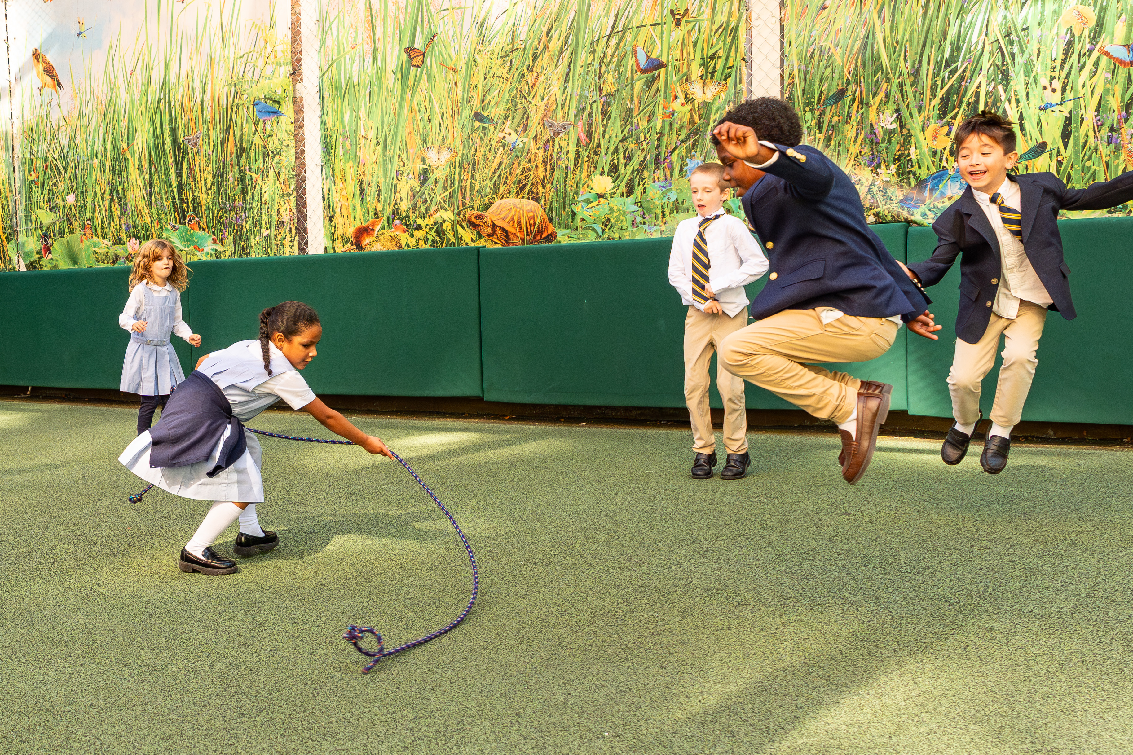 happy children skip rope outside